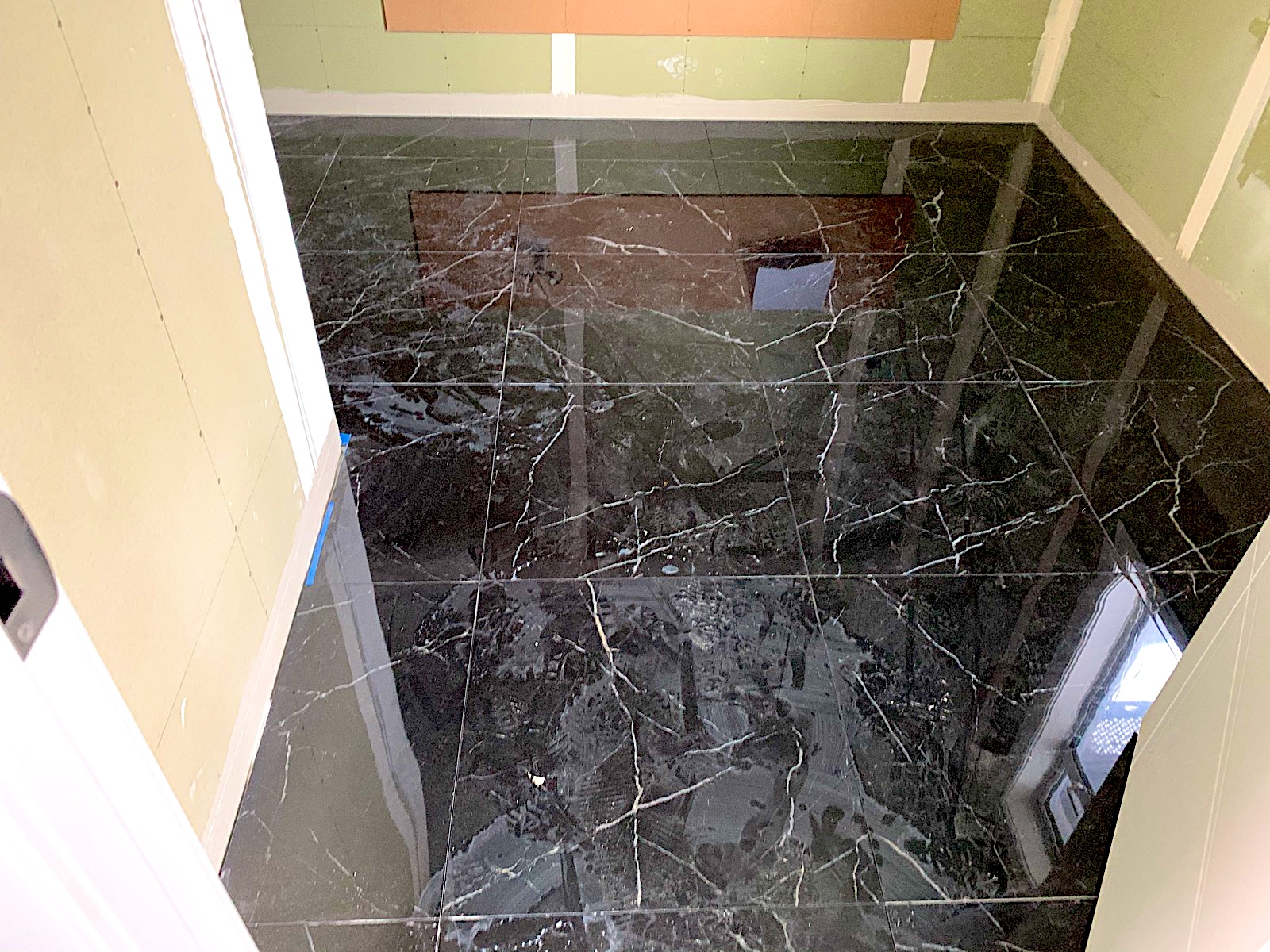 Polished marble-look floor tiling completed by TZ Tiling