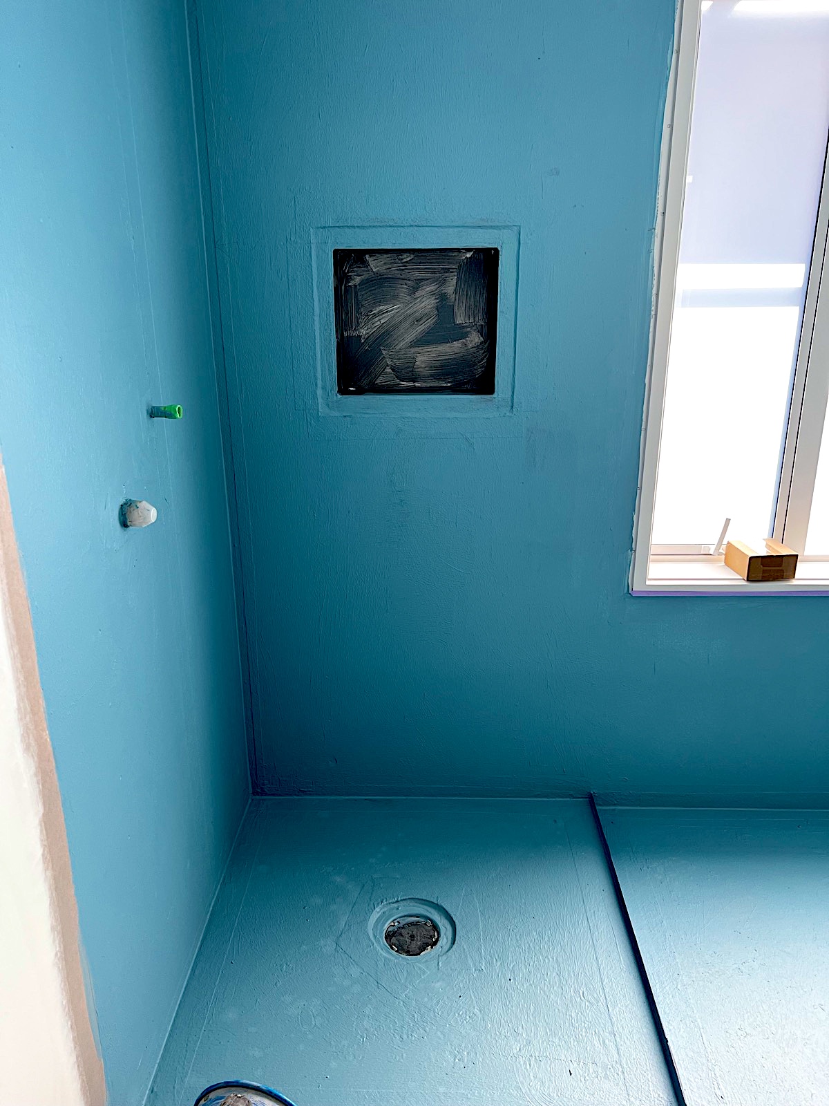 Shower area prepared with blue waterproofing membrane by TZ Tiling